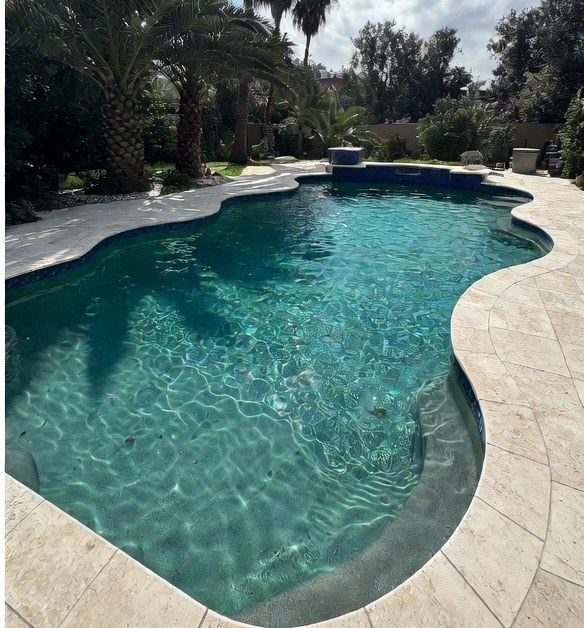 Crystal clear blue residential pool after Paradise Pools cleaning